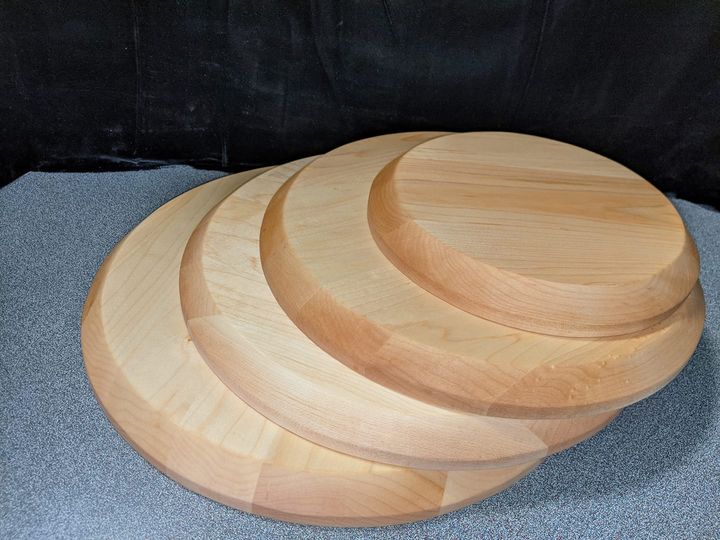 Stack of round wooden Portage Pie rolling boards